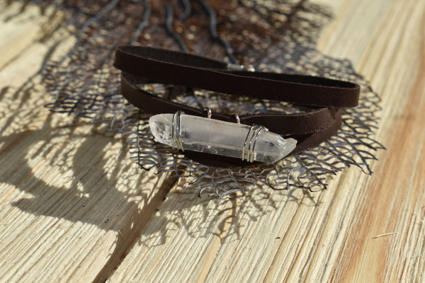 Handmade wire-wrapped quartz and leather wrap bracelet. This hand-picked quartz crystal acts as an energetic cleansing stone. Quartz enhances your connection to source, and keeps your chakras in alignment, helping to clear out any lower vibrations or frequencies. 